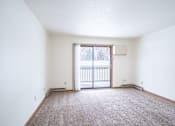 Thumbnail 18 of 30 - A room with a carpeted floor and a sliding glass door. Fargo, ND Long Island Apartments