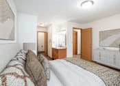 Thumbnail 6 of 30 - A bedroom with a large bed and a television. Fargo, ND Long Island Apartments