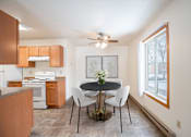 Thumbnail 5 of 30 - A kitchen with a table and chairs in the middle of the room. Fargo, ND Long Island Apartments
