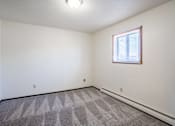 Thumbnail 18 of 23 - A room with a window and a carpeted floor. West Fargo, ND Parkwest Gardens