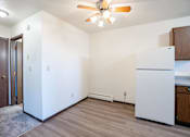 Thumbnail 17 of 23 - A kitchen with a white fridge and a ceiling fan. West Fargo, ND Parkwest Gardens
