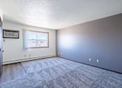 Thumbnail 13 of 23 - A room with a carpeted floor and a window.