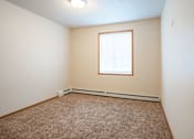 Thumbnail 15 of 24 - A room with a carpeted floor and a window.. Fargo, ND North Sky II Apartments