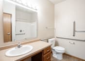 Thumbnail 8 of 24 - A bathroom with a sink, toilet, and shower. Fargo, ND North Sky II Apartments