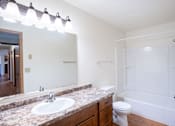 Thumbnail 22 of 25 - A bathroom with a sink, toilet, and bathtub. Fargo, ND Park Place Apartments