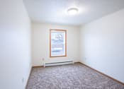 Thumbnail 15 of 25 - A room with a window and a car parked outside. Fargo, ND Park Place Apartments