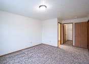 Thumbnail 20 of 25 - A room with a carpeted floor and a ceiling light. Fargo, ND Park Place Apartments