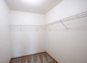 Thumbnail 21 of 25 - Empty room with a shelf and carpeted floor. Fargo, ND Park Place Apartments