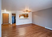 Thumbnail 13 of 25 - A room with a ceiling fan and wooden floors. Fargo, ND Park Place Apartments
