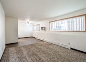 Thumbnail 35 of 43 - A room with a carpeted floor and a window with blinds. Fargo, ND Islander Apartments