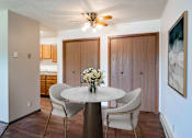 Thumbnail 3 of 15 - A dining room with a round table and chairs. Fargo, ND Summerfield Apartments