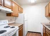 Thumbnail 8 of 15 - A kitchen with a white stove and a white refrigerator. Fargo, ND Summerfield Apartments