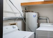 Thumbnail 33 of 39 - A small laundry room with a washer and dryer. Grand Forks, ND Columbia West Apartments