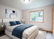 Thumbnail 4 of 14 - A bedroom with a large bed and a window. Fargo, ND Crown Court Apartments