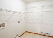 Thumbnail 11 of 14 - Empty white room with shelves and a radiator. Fargo, ND Crown Court 2 Apartments
