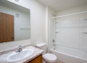 Thumbnail 39 of 43 - A white bathroom with a sink, toilet, and bathtub. Bismarck, ND Sierra Ridge Apartments