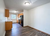 Thumbnail 32 of 43 - A kitchen with a refrigerator, sink, and cabinets. Bismarck, ND Sierra Ridge Apartments