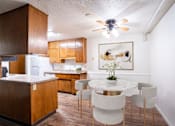 Thumbnail 3 of 14 - A kitchen with a table and chairs. Fargo, ND Park Terrace Apartments