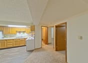 Thumbnail 6 of 7 - A kitchen with wooden cabinets and a white dishwasher.
