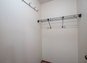 Thumbnail 12 of 14 - A white wall with a black metal rack on it. West Fargo, ND Clearview Apartments
