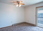 Thumbnail 7 of 14 - A room with a ceiling fan and a window. West Fargo, ND Clearview Apartments