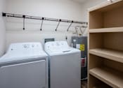 Thumbnail 10 of 14 - Two front loading washing machines in a laundry room. West Fargo, ND Clearview Apartments