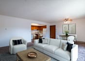 Thumbnail 2 of 14 - A living room with a white couch, a chair, and a coffee table. West Fargo, ND Clearview Apartments