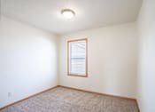 Thumbnail 10 of 28 - A room with a window and carpeted floor. West Fargo, ND Sheyenne Terrace Townhomes