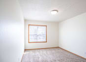 Thumbnail 12 of 28 - A room with a window and carpet on the floor. West Fargo, ND Sheyenne Terrace Townhomes