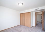 Thumbnail 13 of 28 - A room with a carpeted floor and a white ceiling with a light fixture. West Fargo, ND Sheyenne Terrace Townhomes