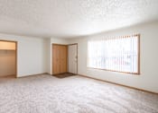 Thumbnail 6 of 28 - A room with two doors and a window with blinds. West Fargo, ND Sheyenne Terrace Townhomes