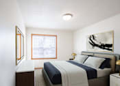 Thumbnail 4 of 28 - A bedroom with a bed, nightstand, and a painting on the wall. West Fargo, ND Sheyenne Terrace Townhomes