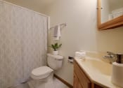 Thumbnail 9 of 10 - a bathroom with a toilet and a sink. Fargo, ND Alden Pines Apartments