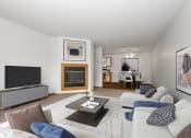 Thumbnail 7 of 29 - a living room with couches and a tv and a fireplace. Anoka, MN Dellwood Estates Apartments
