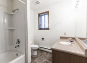 Thumbnail 6 of 6 - Bismarck, ND Arbor apartments. a bathroom with a toilet sink and bathtub