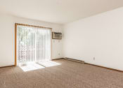 Thumbnail 7 of 16 - a bedroom with a sliding glass door and carpeted floor