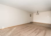Thumbnail 4 of 7 - Grand Forks, ND Barrette Arms Apartments.  a living room with white walls and a beige carpet