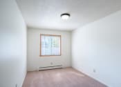 Thumbnail 19 of 25 - an empty room with white walls and a window. Fargo, ND Betty Ann Apartments