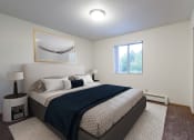 Thumbnail 4 of 11 - a bedroom with a bed and a window. Bismarck, ND Belmont East Apartments