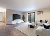 Thumbnail 1 of 11 - a living room with a couch and a tv