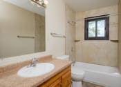 Thumbnail 8 of 16 - a bathroom with a sink and a toilet and a shower. Fargo, ND Birchwood 2 Apartments