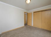 Thumbnail 7 of 16 - a bedroom with a closet and carpeted floors. Fargo, ND Birchwood 2 Apartments