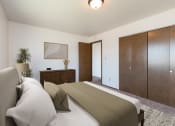 Thumbnail 3 of 6 - Bismarck, ND Brentwood II Apartments. A bedroom with a bed and dresser Brentwood II| Bismarck, ND
