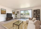Thumbnail 1 of 6 - Bismarck, ND Brentwood II Apartments. A living room with a couch and a coffee table