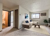 Thumbnail 1 of 7 - Bismarck, ND Eagle Sky II. a small living room with a couch and a coffee table a small window lets natural light in.