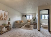 Thumbnail 4 of 7 - Bismarck, ND Eagle Sky II. a small living room with a couch and a coffee table a small window lets natural light in.