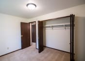 Thumbnail 14 of 16 - A bedroom with a closet. Bismarck, ND Eastbrook Apartments.