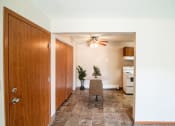Thumbnail 2 of 16 - A dining room with a table and a ceiling fan. Bismarck, ND Eastbrook Apartments.