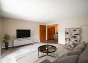 Thumbnail 1 of 16 - A living room with a couch and a coffee table. Bismarck, ND Eastbrook Apartments.