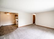 Thumbnail 9 of 16 - Bismarck, ND Eastbrook Apartments. A living room with the dining room in the background